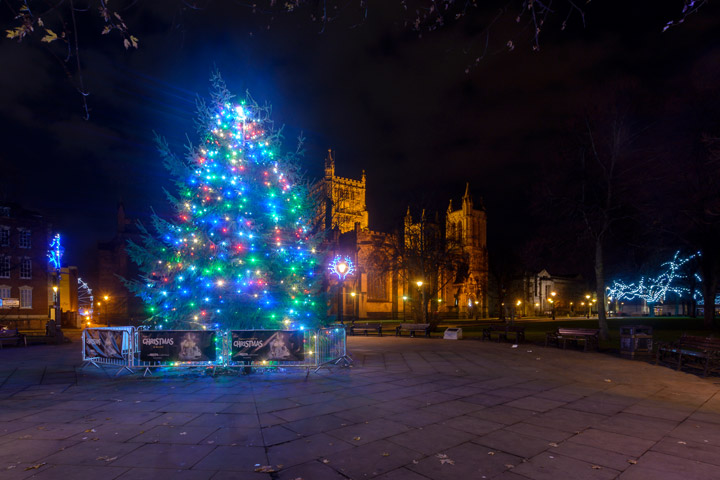 Illuminated Christmas tree at night in front of Bristol Cathedral.