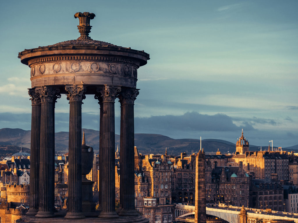 Elevated  view of Edinburgh in October from Calton Hill with monument in foreground.