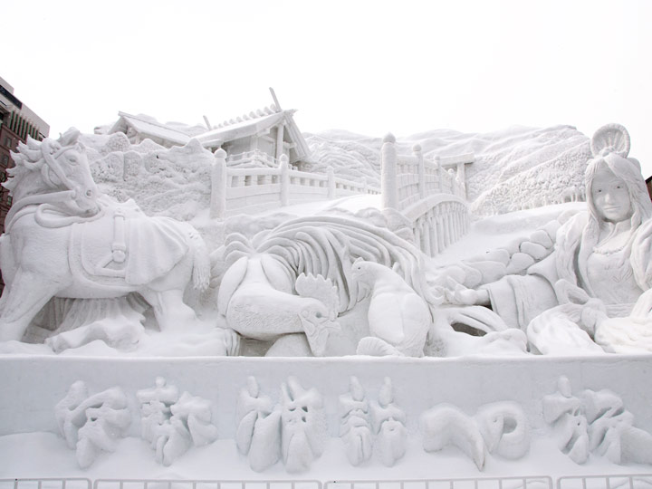 Elaborate snow sculpture of animals and castle at Sapporo Snow Festival.