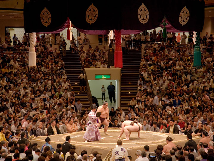 Sumo match with view of ring and crowd.