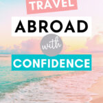 Beach shore with blue and pink sky, with text overlay - "How to travel abroad with confidence".