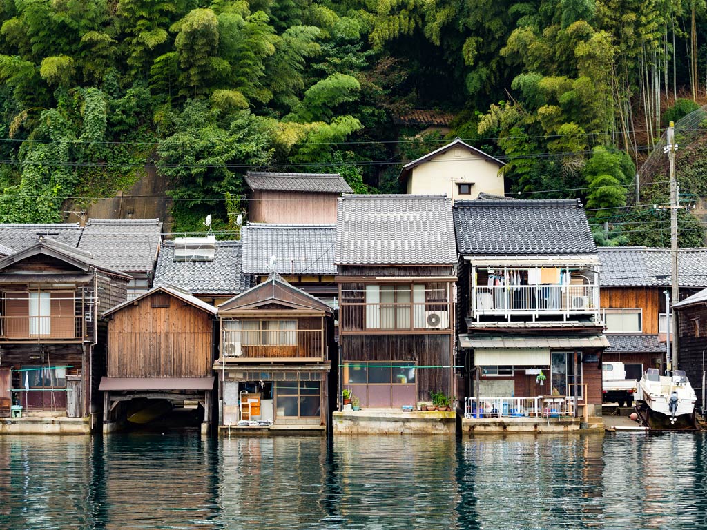 Wooden facades of fisherman's houses in Funaya, an easy day trip from Kyoto.