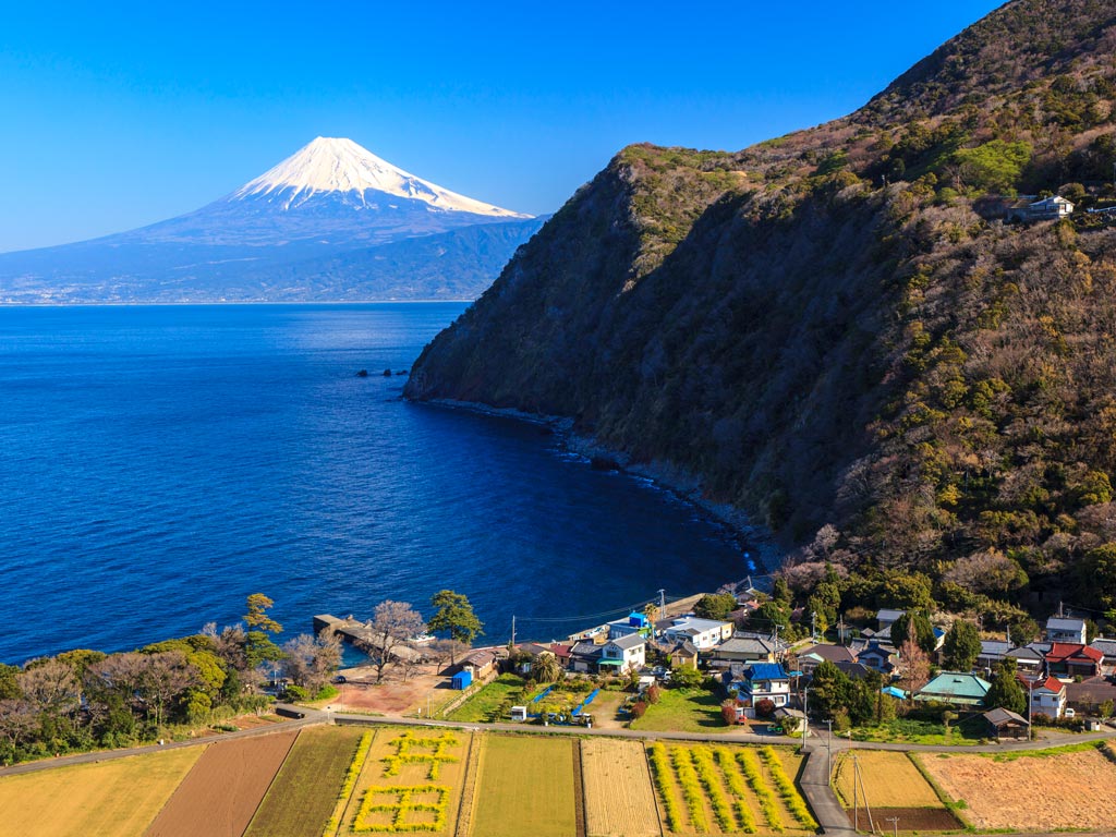 Bayside view of Mount Fuji and small farming village in Japan off the beaten path.