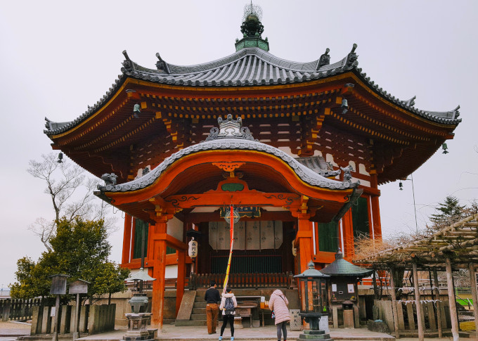 Things to avoid in Japan: photographing people too closely at a temple.