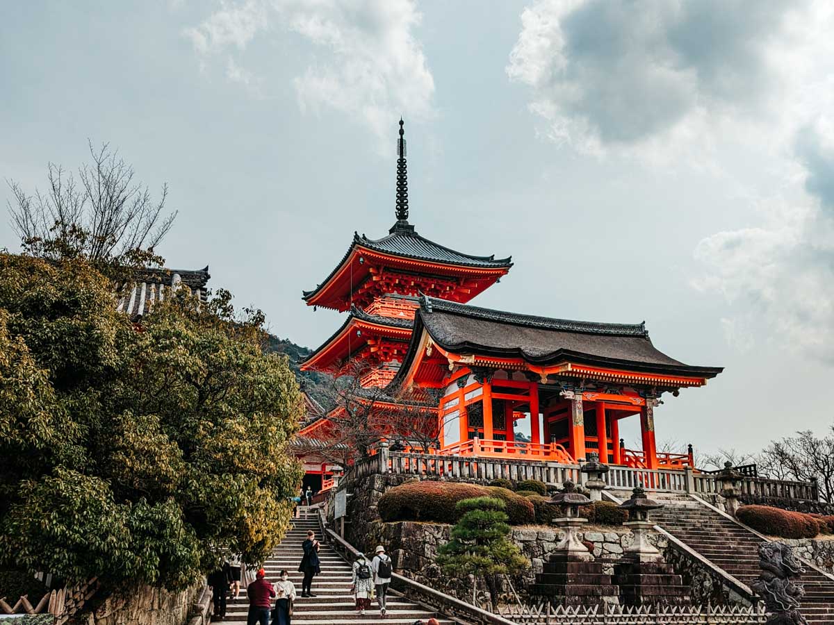 Stone steps leading up to Kiyomizudera side gate and small pagoda.