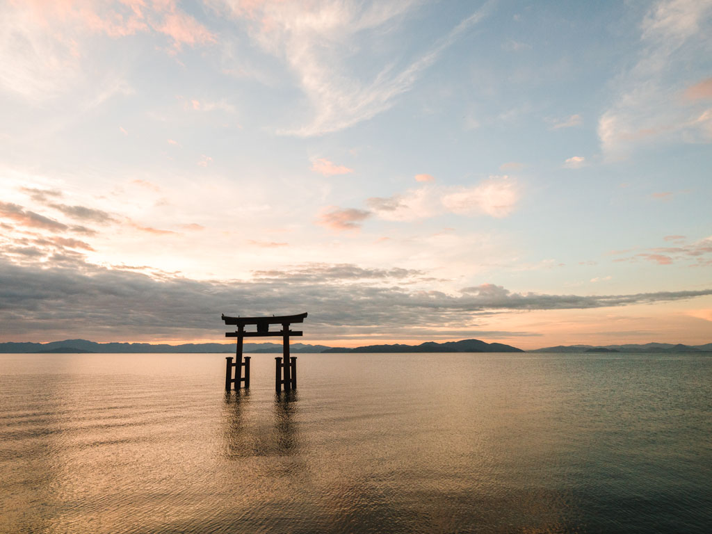 Floating torii gate at sunrise, a popular place to visit during a Lake Biwa day trip.