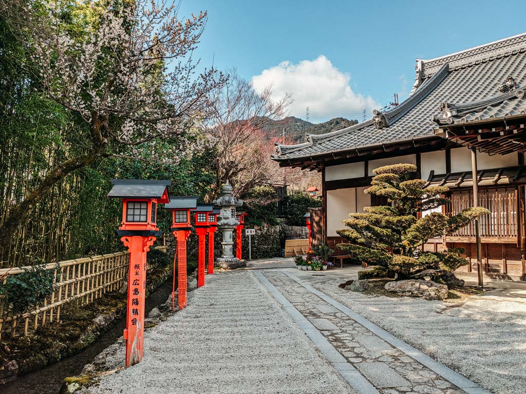 Japanese shrine with pebble landscape and orange lanterns in Lake Biwa Japan.