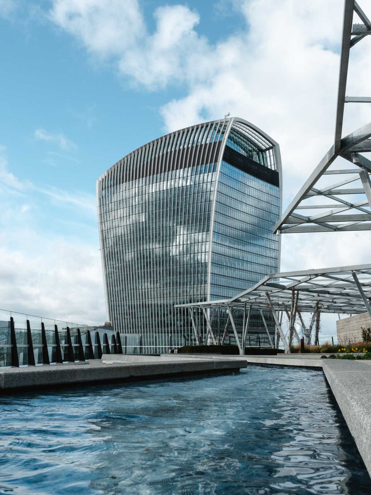 Rooftop area of The Garden at 120 with water feature and view of London Walkie Talkie building.