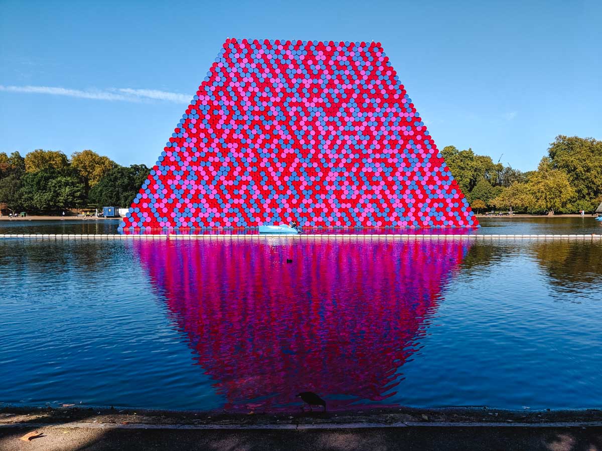 Colorful trapezoid art installation floating on pond in Hyde Park London.