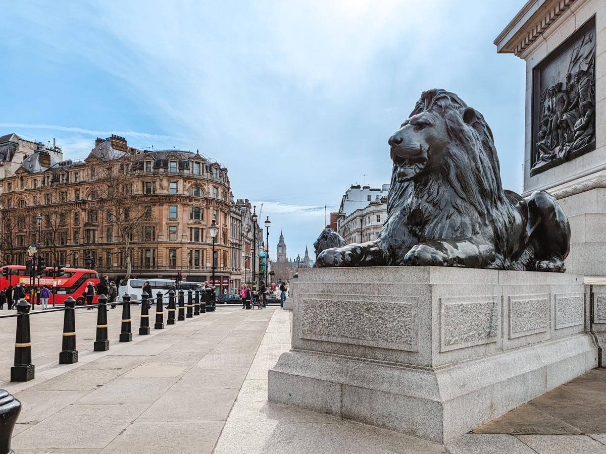 Lion statue with Big Ben and red double decker bus in distance seen during 4 days in London.