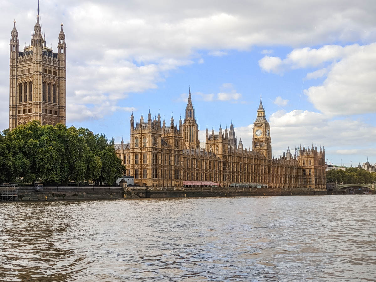 Exterior of Houses of Parliament along Thames River.