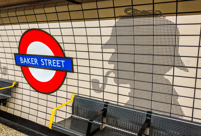 Bakerloo tube station with Sherlock Holmes silhouette on wall.