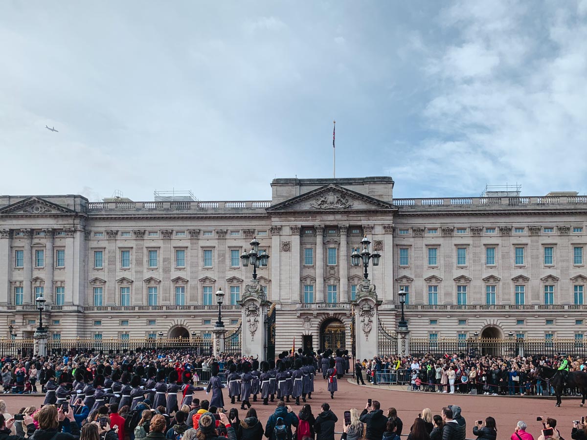 Changing of the Guard ceremony with onlookers in front of Buckingham Palace London.