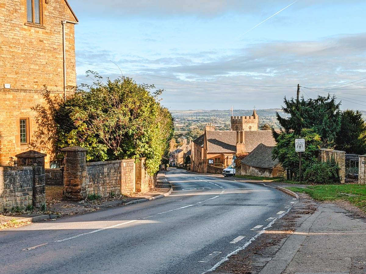 Sunset over Cotswolds stone houses and street seen during London to Scotland road trip itinerary.