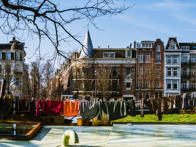 Colorful travel capsule wardrobe Europe hanging on clothesline.