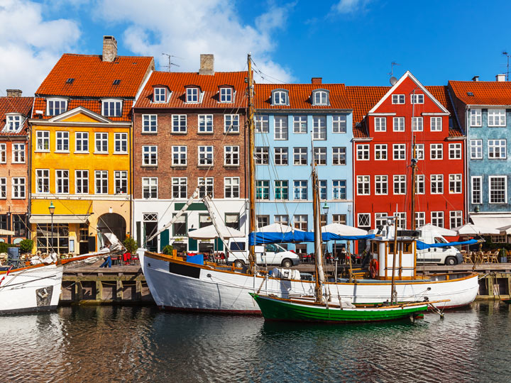 Colorful houses and boats on river of Copenhagen Nyhaven district.