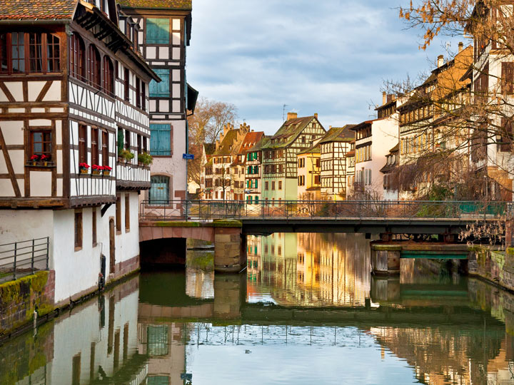 Strasbourg river view of bridge and half-timbered houses on either size.