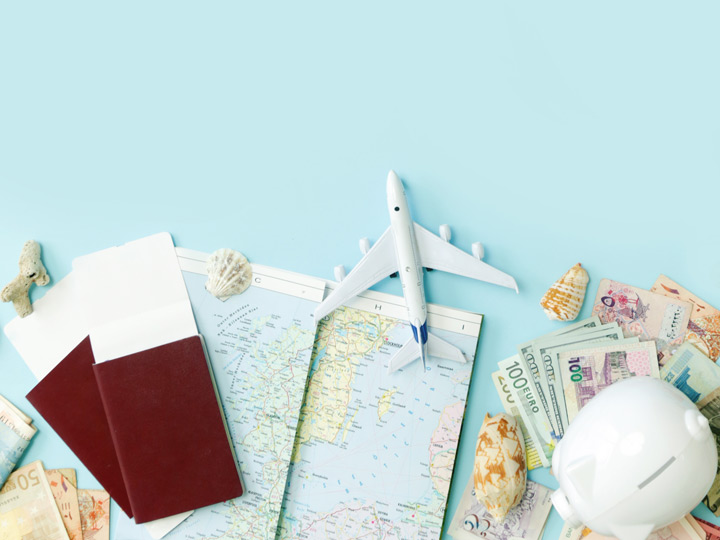 Moving abroad checklist concept with passports, map, money, and toy plane.