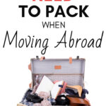 What you need to pack when moving abroad - overflowing vintage suitcase