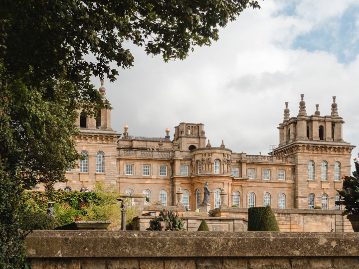 View of England's Blenheim Palace facade with numerous windows and turrets