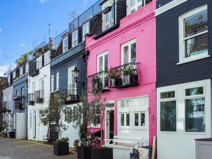 Pink and blue facades of St. Luke's Mews, a much requested neighborhood for London relocation agents.