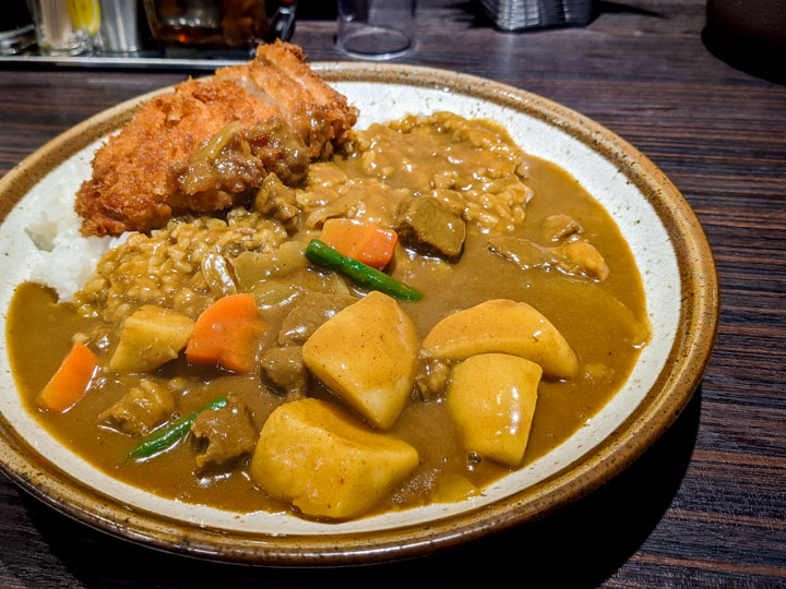 Katsu curry with potato and carrot curry sauce and stick rice, a must try food in Japan.