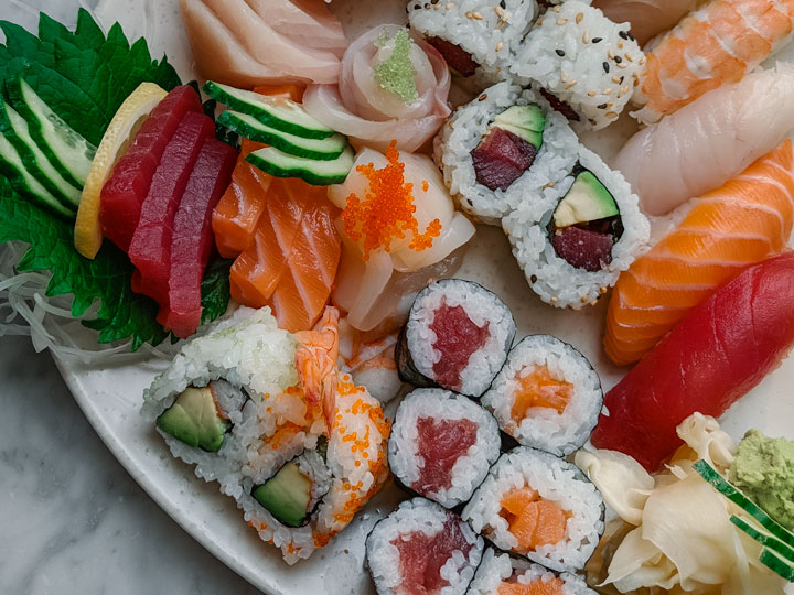 Colorful plate of sushi rolls and nigiri, a must eat food in Japan.