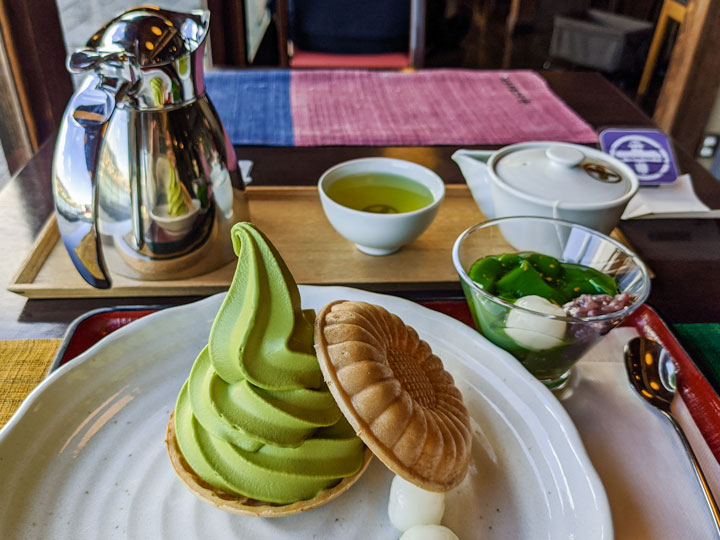 Table with green matcha ice cream, matcha pudding, matcha green tea, and metal pitcher.