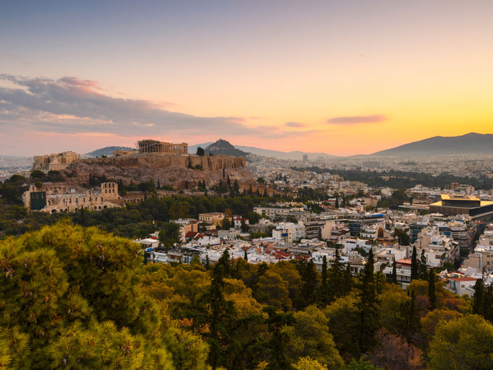 Sunset over Athens city with Acropolis in distance.