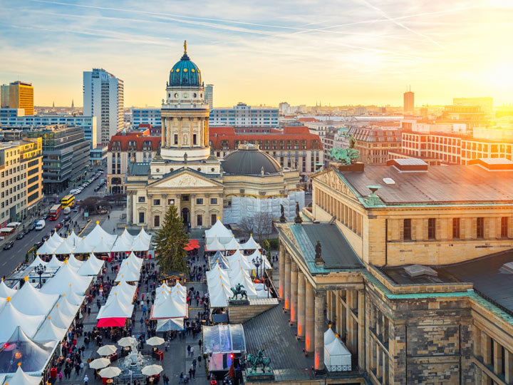 Sunrise over Berlin Christmas market and skyline.