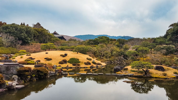 Nara Isuien Garden with pond and grassy hills.