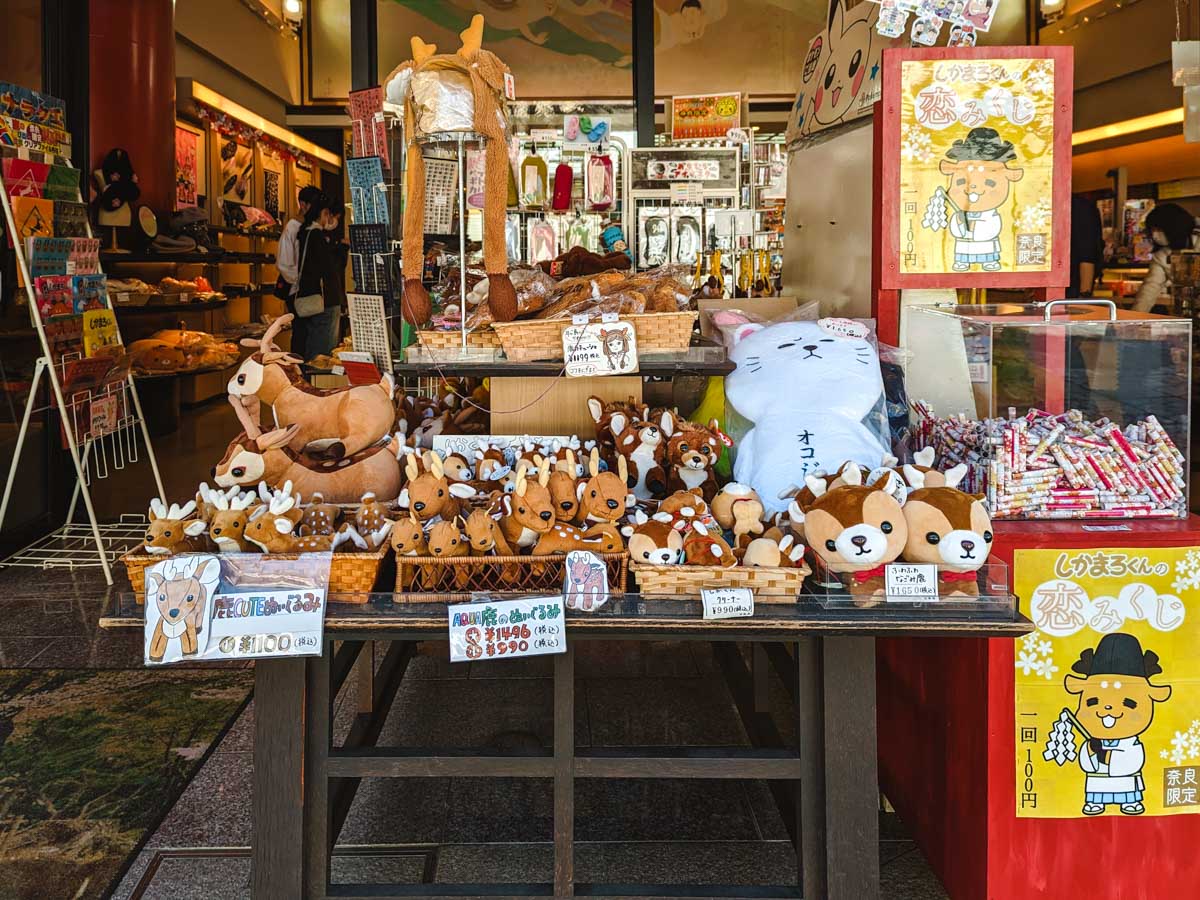 Table of deer themed souvenirs to buy during Nara day trip itinerary.