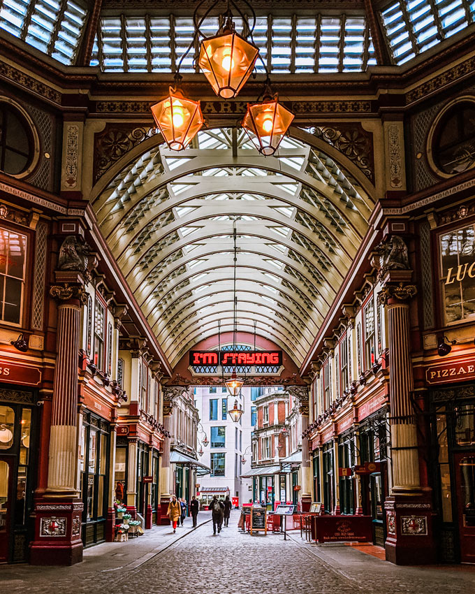 Interior of Leadenhall Market with glass arched ceiling and lantern.