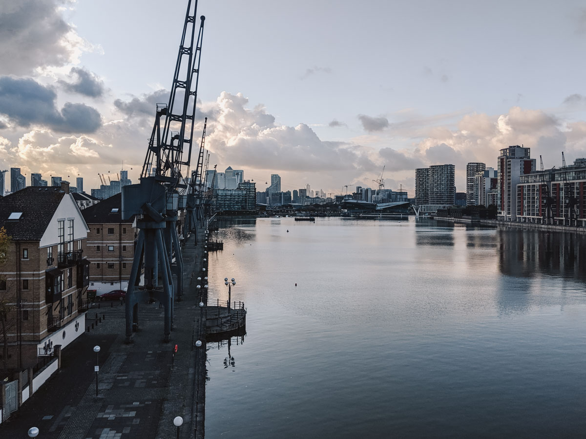 View of Thames River and London city skyline at sunset.