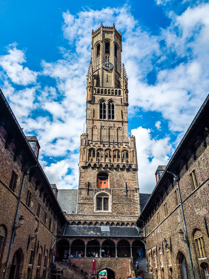 Walking towards Bruges belfry bell tower.