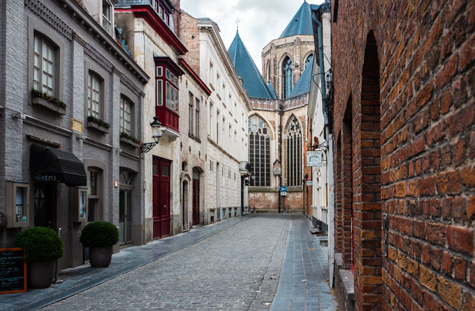 Bruges walking tour view of church from alley.