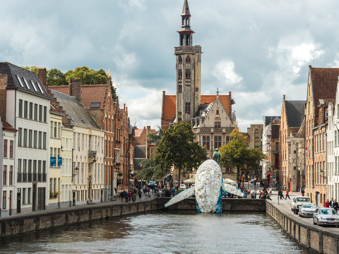 Bruges walking tour view of whale leaping from canal.