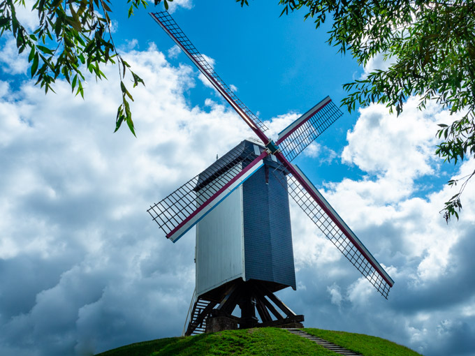 Sint Janhuis Windmill against cloudy sky in Bruges.