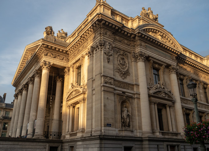 Exterior of Brussels Stock Exchange with Greek-style columns and sculptures.