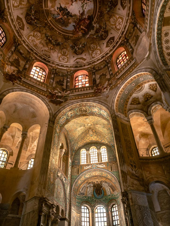 Ravenna Basilica di San Vitale interior view of apse, dome, and alcove mosaics and murals.