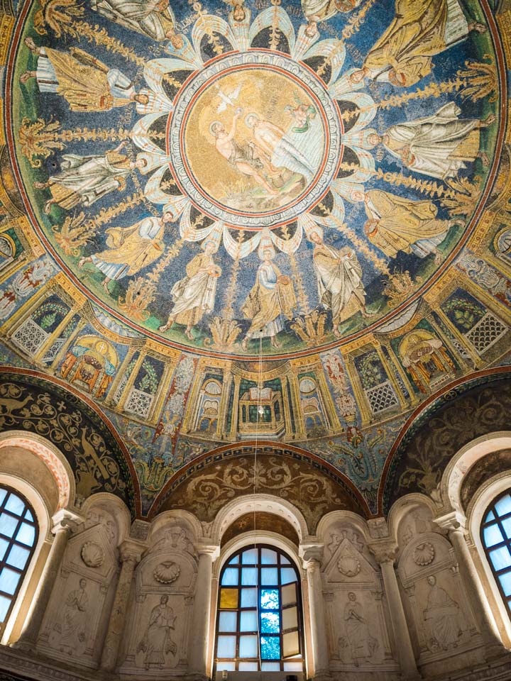 Mosaic dome and windows of Baptistry of Neon, an essential stop on the Ravenna itinerary.