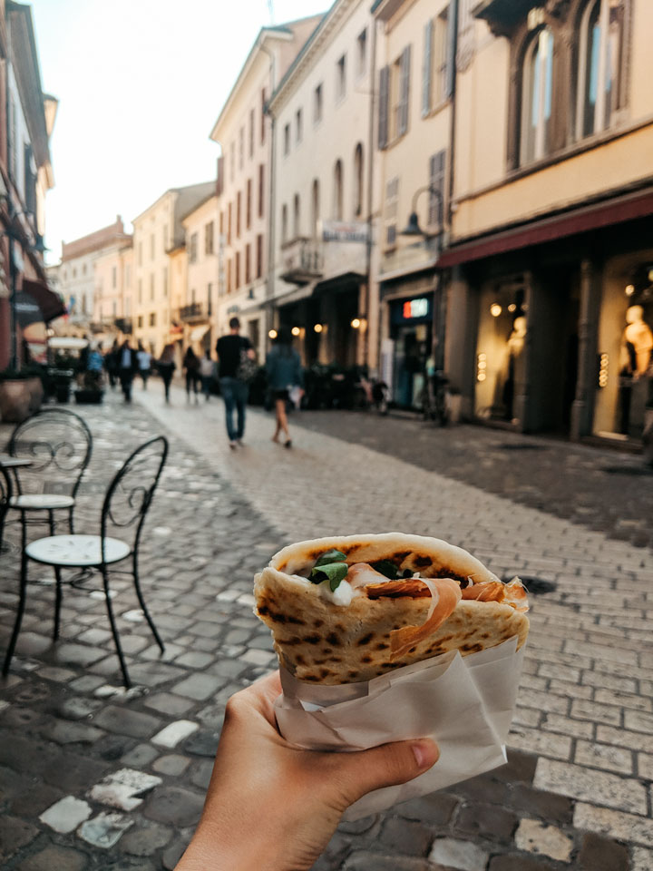 Piadina sandwich with Ravenna street in background.