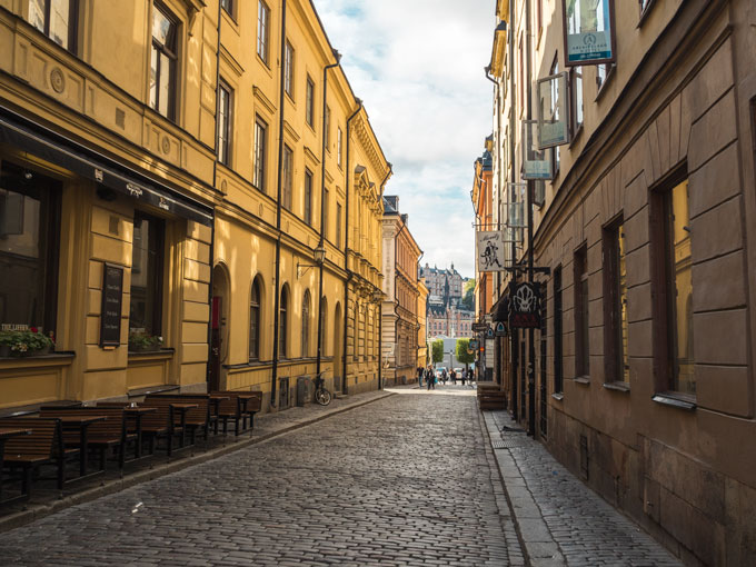Stockholm Gamla Stan Alley lined with yellow and brown buildings.