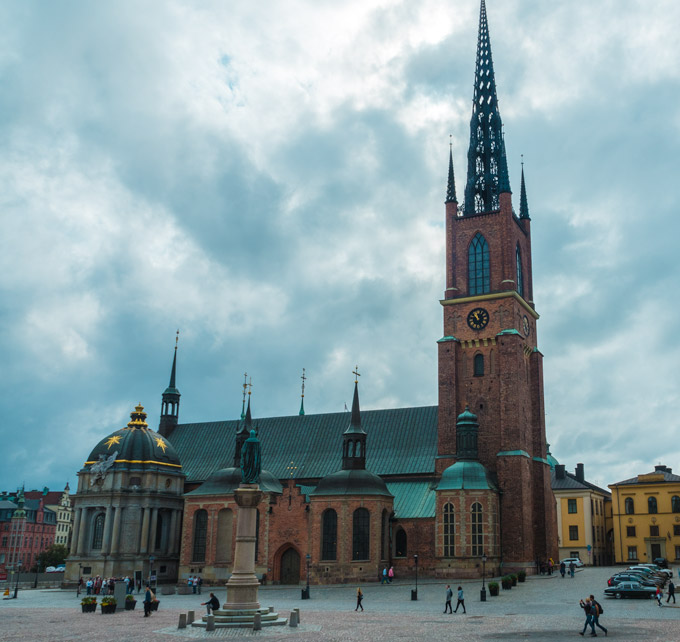 Stockholm Riddarholmen Church exterior on dark cloudy day.