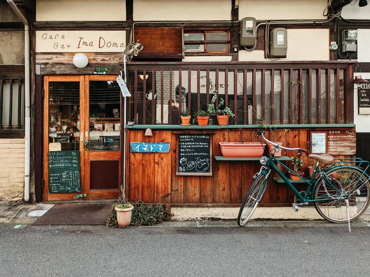 Wooden cafe facade with vintage bicycle out front.