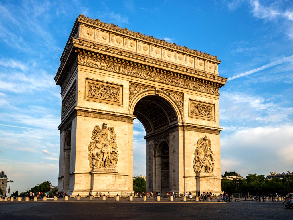 Paris Arc de Triomphe against blue sky.