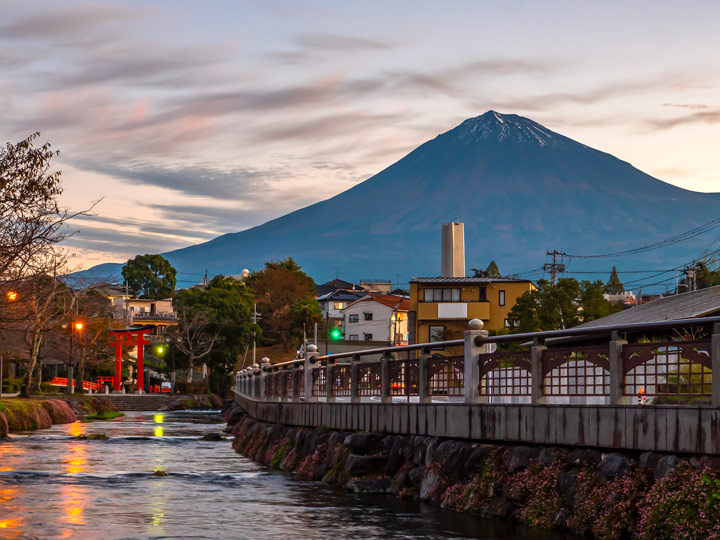 Fujinomiya town at blue hour with Mount Fuji in distance.