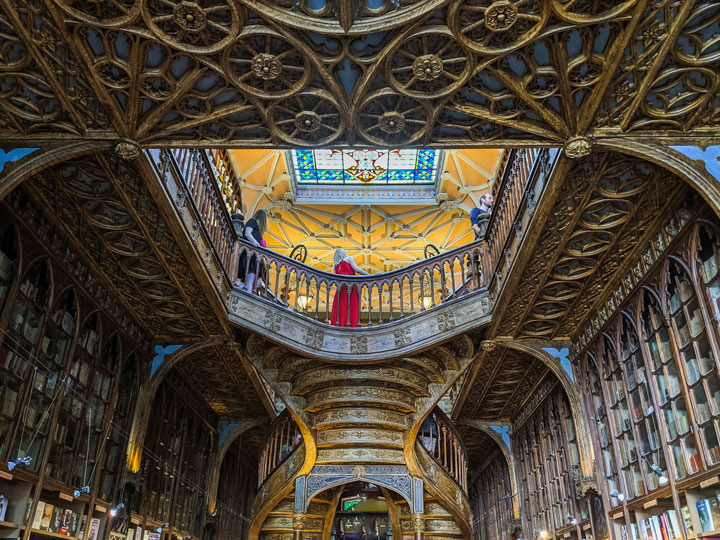 Interior of Livraria Lello staircase and bookshelves, a popular place to visit in Porto.