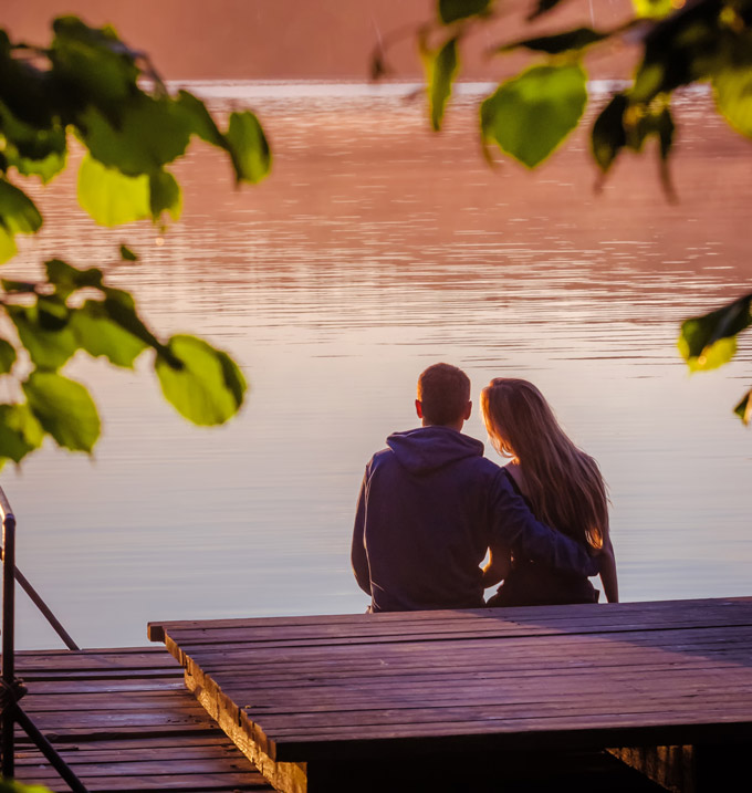 Couple next to water having a romantic Lake District break.