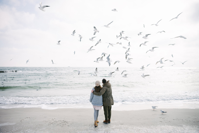 Two people on beach having a romantic staycation for couples.